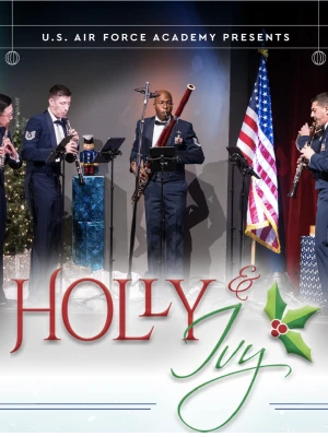 A five-member band performs on stage with U.S. flag, holiday decorations, and “Holy & Jolly” title text at the bottom.