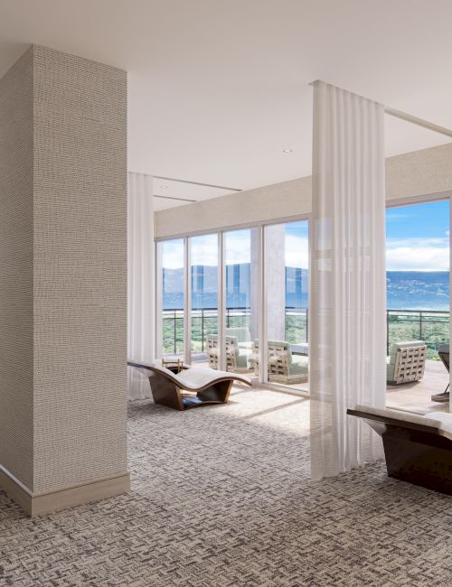 A spacious, modern living area with large windows, comfortable seating, and outdoor views, separated by sheer curtains.