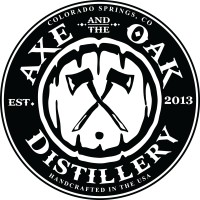 A round black-and-white logo for Axe Oak Distillery, with a carved jack-o&rsquo;-lantern face, &ldquo;AXE OAK DISTILLERY&rdquo; text, and &ldquo;Colorado Springs CO EST. 2013.&rdquo;