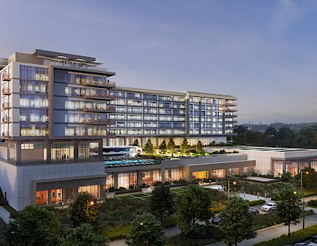The image shows a modern multi-story building with glass balconies, surrounded by greenery, cars, and an outdoor pool area.